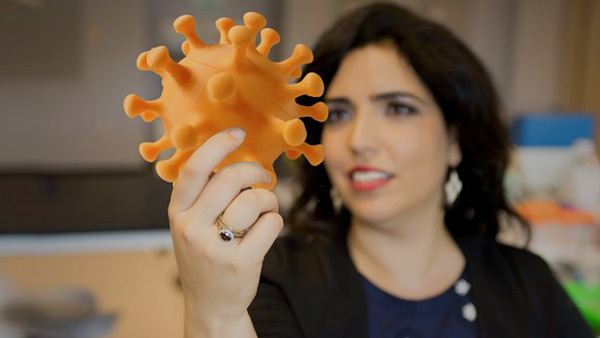 woman holding 3d print of molecule