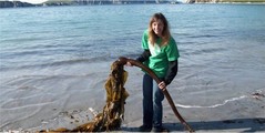 Woman holding a large piece of kelp