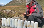 Raymond Bradley takes a photo of the sediment samples acquired from Lake Igaliku, southern Greenland.  Image credit: Isla Castañeda 