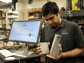 Prabhav Borate demonstrates how lab earthquakes are created: grinding blocks of rock together until failure occurs. Credit: Poornima Tomy/Penn State