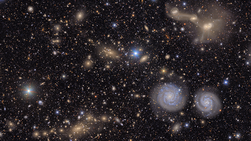 NSF-DOE Rubin captures many stars and galaxies including two spiral galaxies and three merging galaxies.