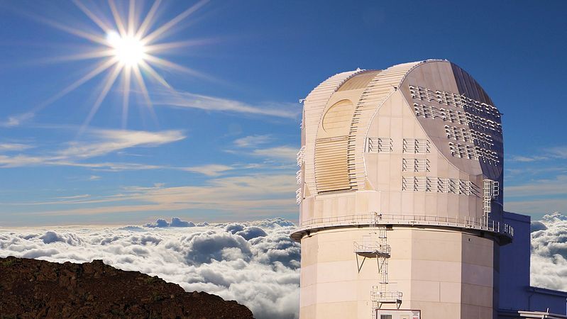 NSF Inouye Solar Telescope on the mountain summit above the clouds.