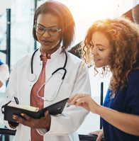 Image shows two African American, female health professionals