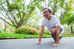 Older Asian American Man Preparing to Run