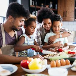 Image shows a Black family preparing breakfast