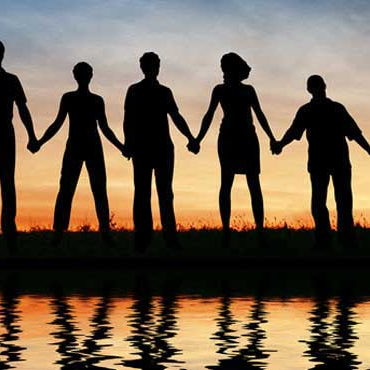 Image shows silhouettes of people holding hands
