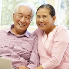 Image shows an older Asian man and woman, smiling