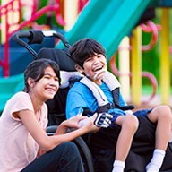 Image shows a mother and her special needs child at a public park