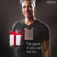The good in you can live on. Picture shows a Latino man holding a gift box that represents his donated organs. 