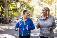 Image of two women engaging in physical activity outdoors.