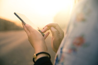 Image of a woman holding a smartphone.