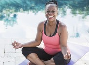 smiling woman on yoga mat