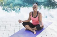 smiling woman on yoga mat