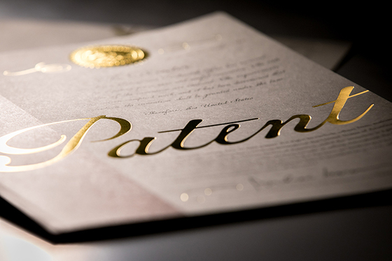 A photo of the newly redesigned patent cover, featuring the word "patent" inscribed in gold leaf lettering.