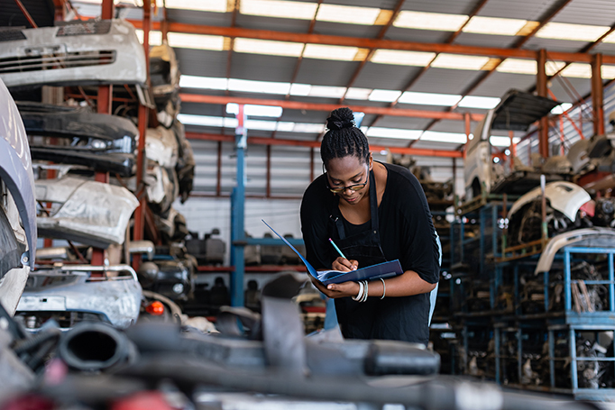Woman taking inventory of car parts