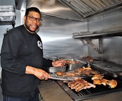 Christopher Finnick CEO & Owner of Mama's Southern Style BBQ 2 behind the grill