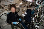 NASA astronaut Kayla Barron sets up the Mochii microscope