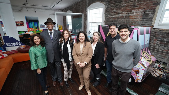 Seven people standing indoors.