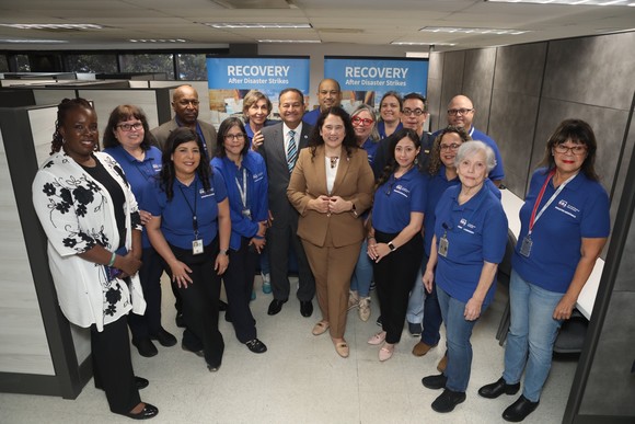 Administrator Guzman stands with a group of people inside a Business Recovery Center in Puerto Rico 