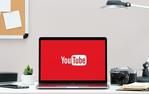 image of a desk with a computer and the youtube logo on it