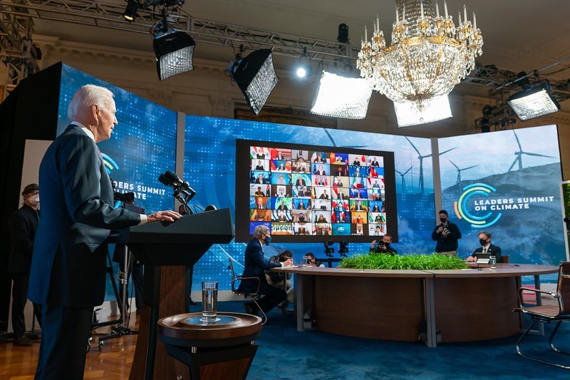 President Biden kicks off the Leaders Summit on Climate, with over forty virtual participants shown on a large television monitor. 