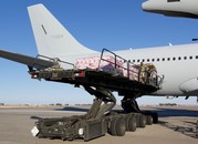 Cases of vaccines are lifted to be loaded into an airplane.