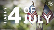 Two small flags of the United States displayed in a glass jar and the words 