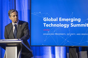 Secretary Blinken in front of a podium in front of a screen that reads “Global Emerging Technology Summit”.