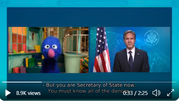 Video still of Secretary Blinken next to Grover from Sesame Street.