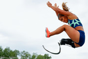 An athlete with a prosthetic leg jumping. 