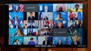 TV monitor showing participants of virtual meeting.