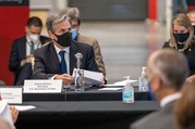 Secretary Blinken, wearing a mask, sitting at a table during the U.S.-EU Trade and Technology Council meetings.