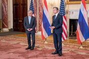 Secretary Blinken and Thai Prime Minister and Foreign Minister Pramudwinai stand and speak in a formal room, with their country flags behind them.