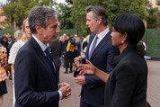 Secretary Blinken speaks to former Secretary of State Condoleezza Rice at an outdoor gathering.