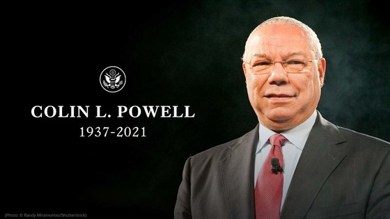 Colin Powell, wearing a suit with a red tie, and the words “Colin Powell, 1937-2021”. 