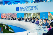 World leaders seated in front of a blue screen with the words “G20 Rome Summit 30-31 October 2021”.  
