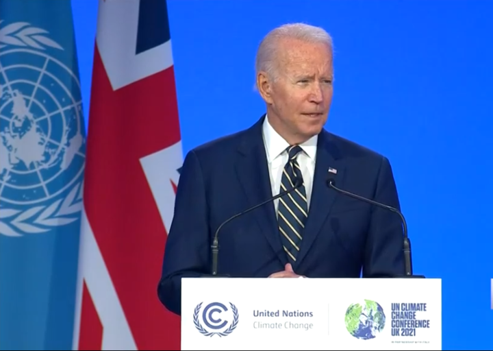 President Biden speaks at a podium at COP26