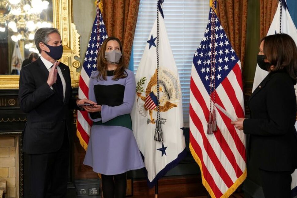 U.S. Secretary of State Antony Blinken, with his wife Evan Ryan at his side, is ceremonially sworn in by U.S. Vice President Kamala Harris.