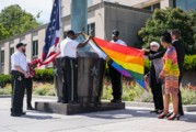 Department of State officials and guards raising the U.S. and LGTBQI+ flags. 