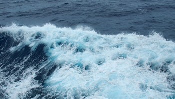 Stock photo of rough seas showing dark blue ocean water with choppy white waves.