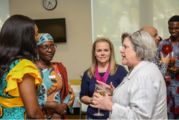 U.S. Ambassador to Abuja Mary Beth Leonard holding a glass and speaking to women from a side profile. 