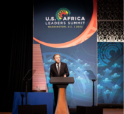 Secretary Blinken speaks at a podium. A banner behind him reads "U.S. Africa Leaders Summit Washington, D.C. | 2022"