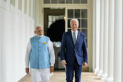 President Biden and Prime Minister Modi walk along the Colonnade of the White House.