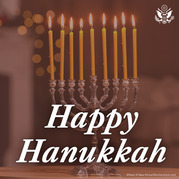 Menorah with lighted candles with text: Happy Hanukkah