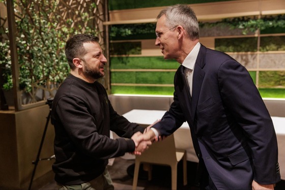 NATO Secretary General Jens Stoltenberg and President of Ukraine Volodymyr Zelenskyy shake hands.