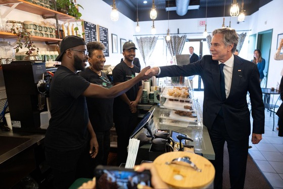 Secretary Blinken shakes hands with workers at Emma’s Torch in Washington, D.C.