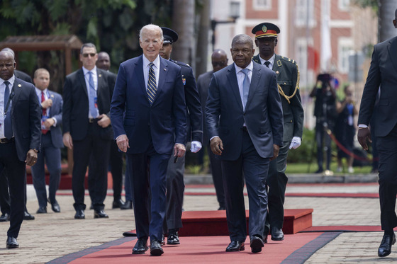 President Biden walks down a red carpet with President João Lourenço of the Republic of Angola.