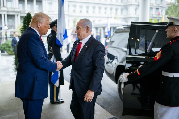 President Donald Trump shaking hands with Prime Minister Benjamin Netanyahu outside of building