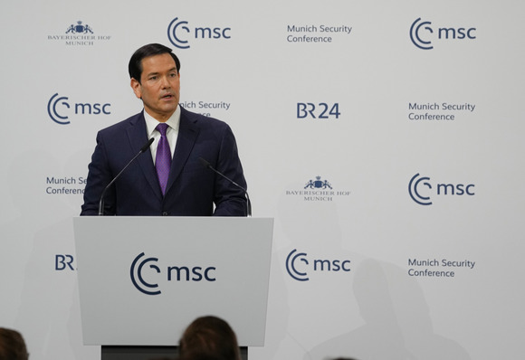 Secretary Rubio stands behind a podium and speaks to an audience.