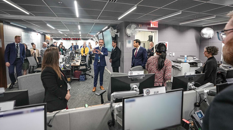 Secretary Rubio in a government office surrounded by State Department employees. 